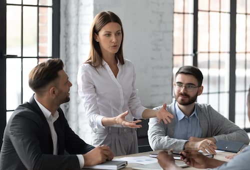 woman standing and talking in meeting