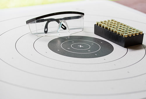 target sheet with safety glasses and ammunition